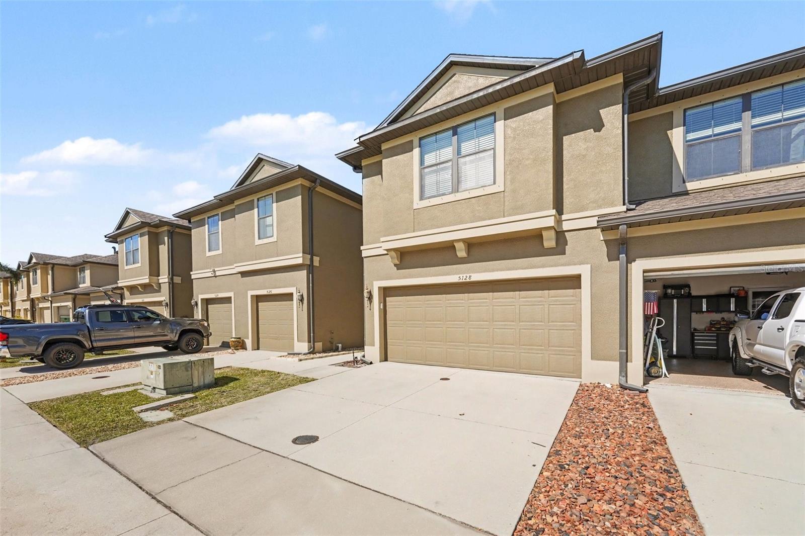 View of the exterior showcasing the rare and spacious 2-car garage, providing ample parking and storage.