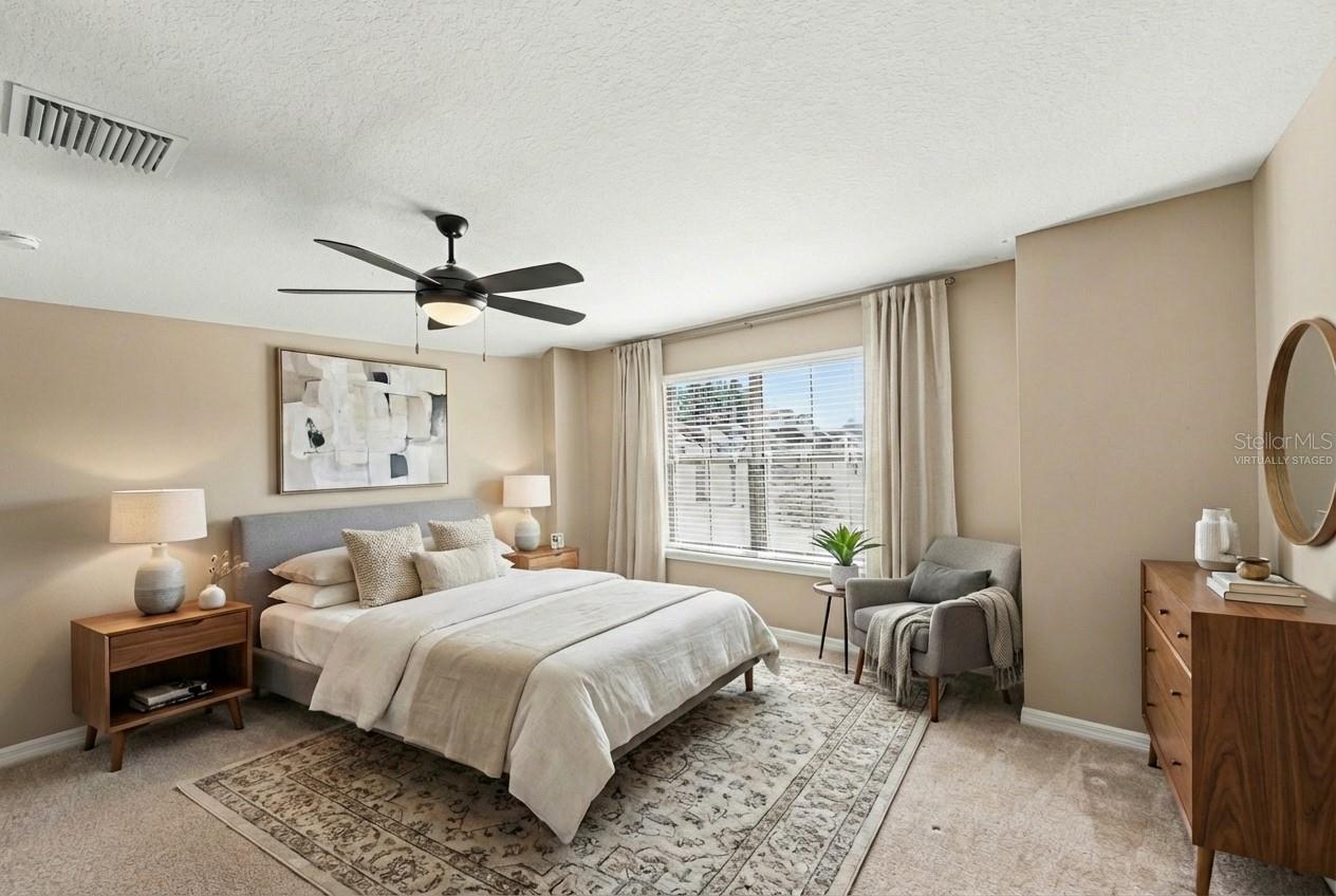 Virtually Staged view of the primary suite, demonstrating the room's generous proportions and potential.