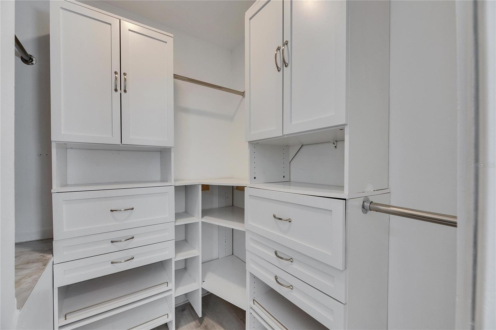 Master Walk-in closet with built in shelving and storage