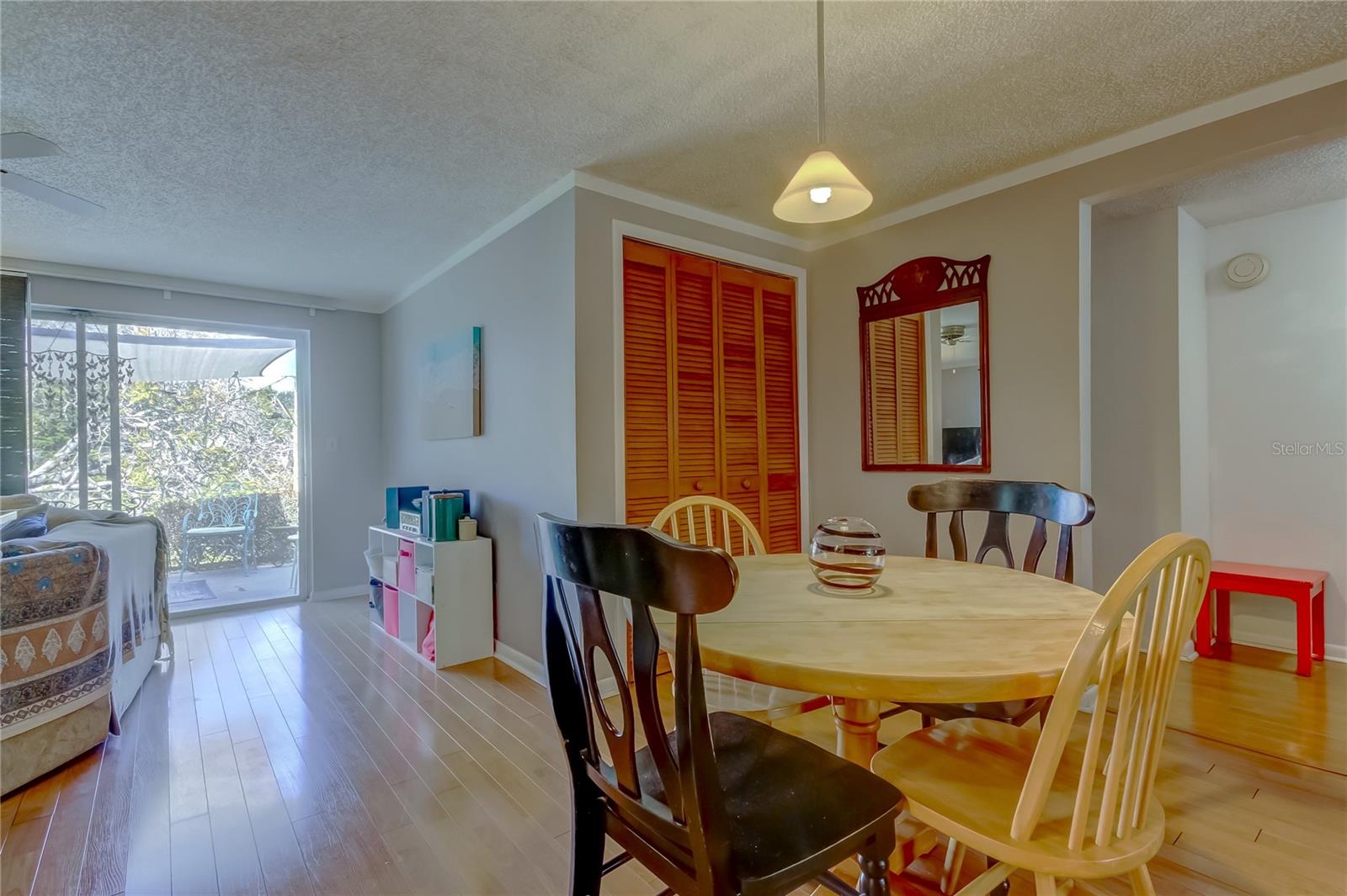Dining room with back yard/pond view, closet, and entry to bedrooms