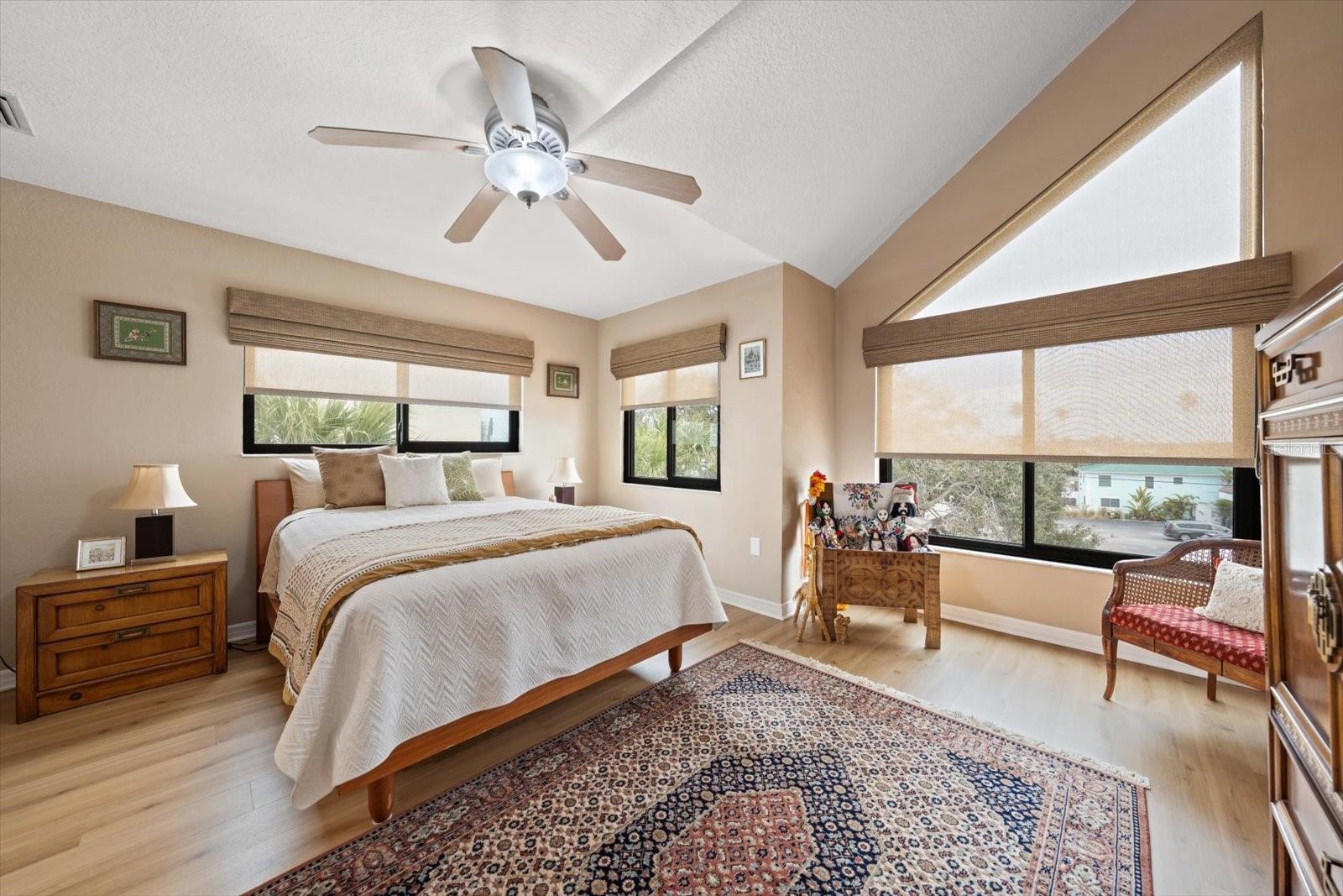 Guest bedroom on third level with new impact windows, and attractive window treatments.