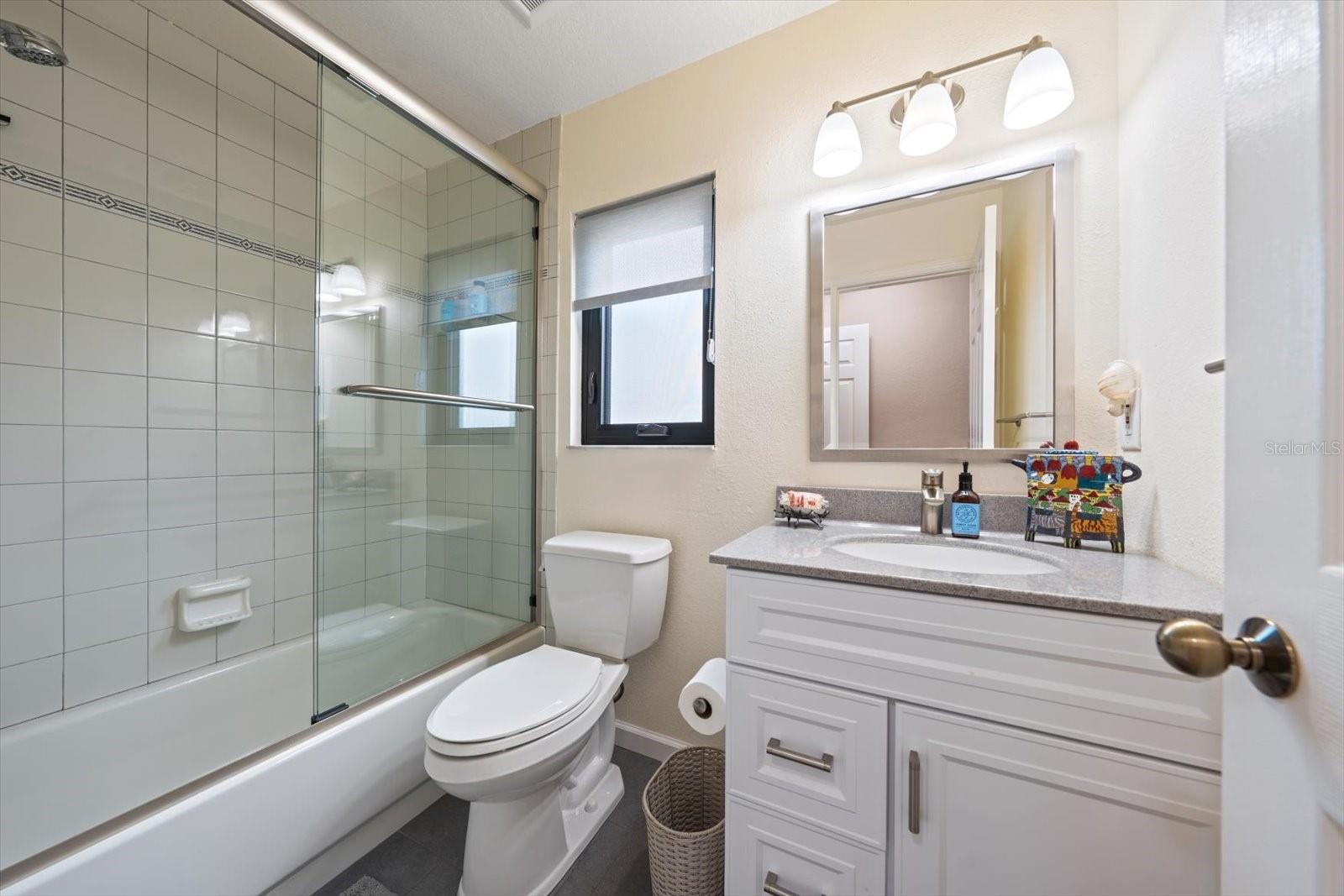 Tastefully updated guest bath.