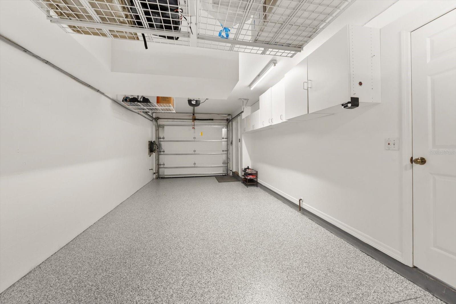 Garage area with notable storage-beautifully maintained and accommodates 2 cars.