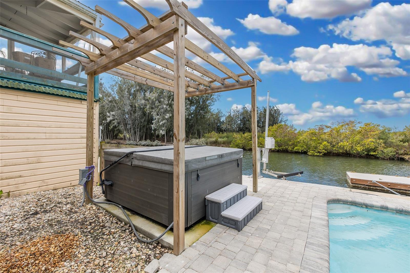 Jacuzzi overlooking pool and canal