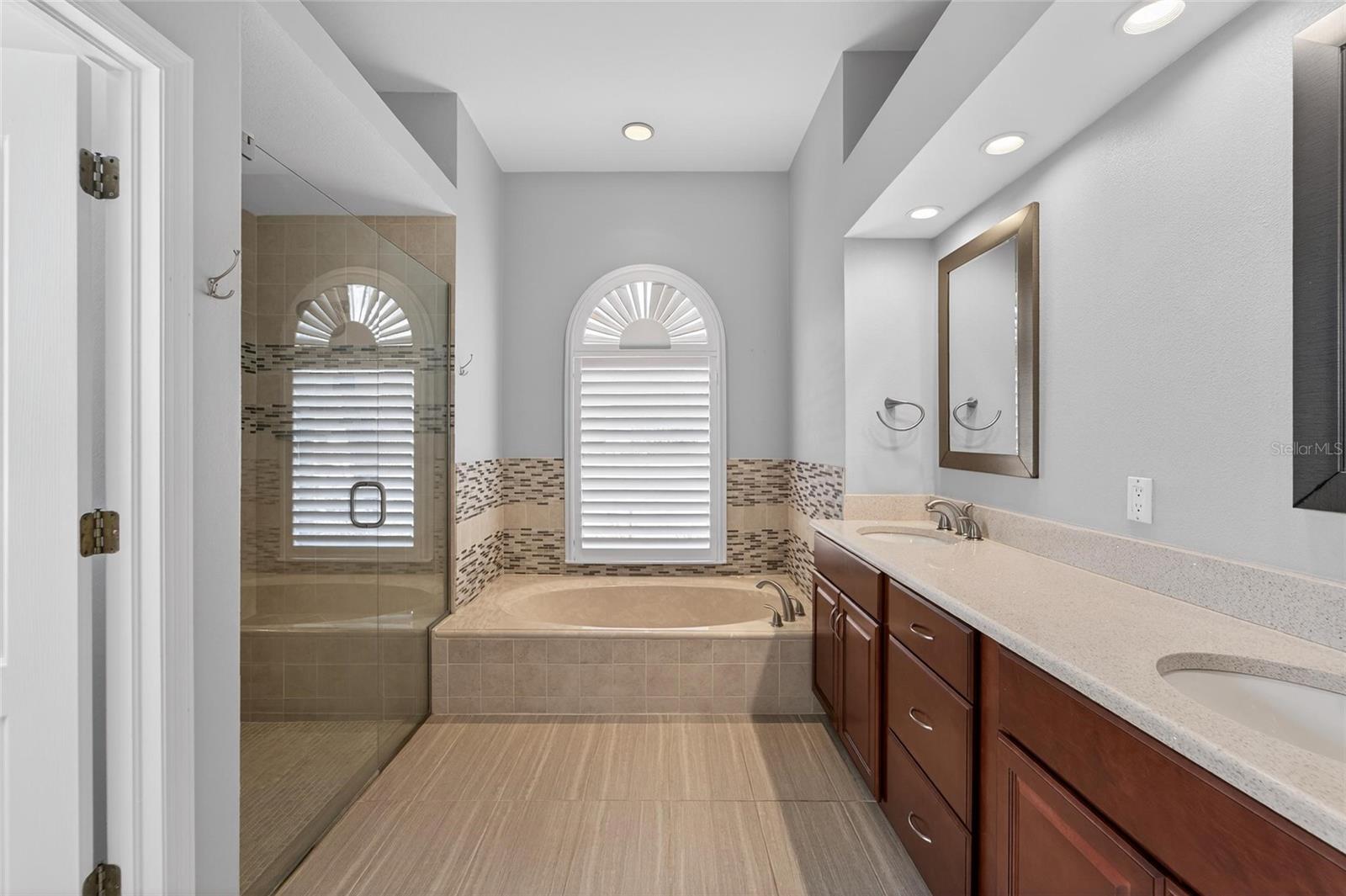 En-suite primary bathroom - solid stone counters/dual sink vanity