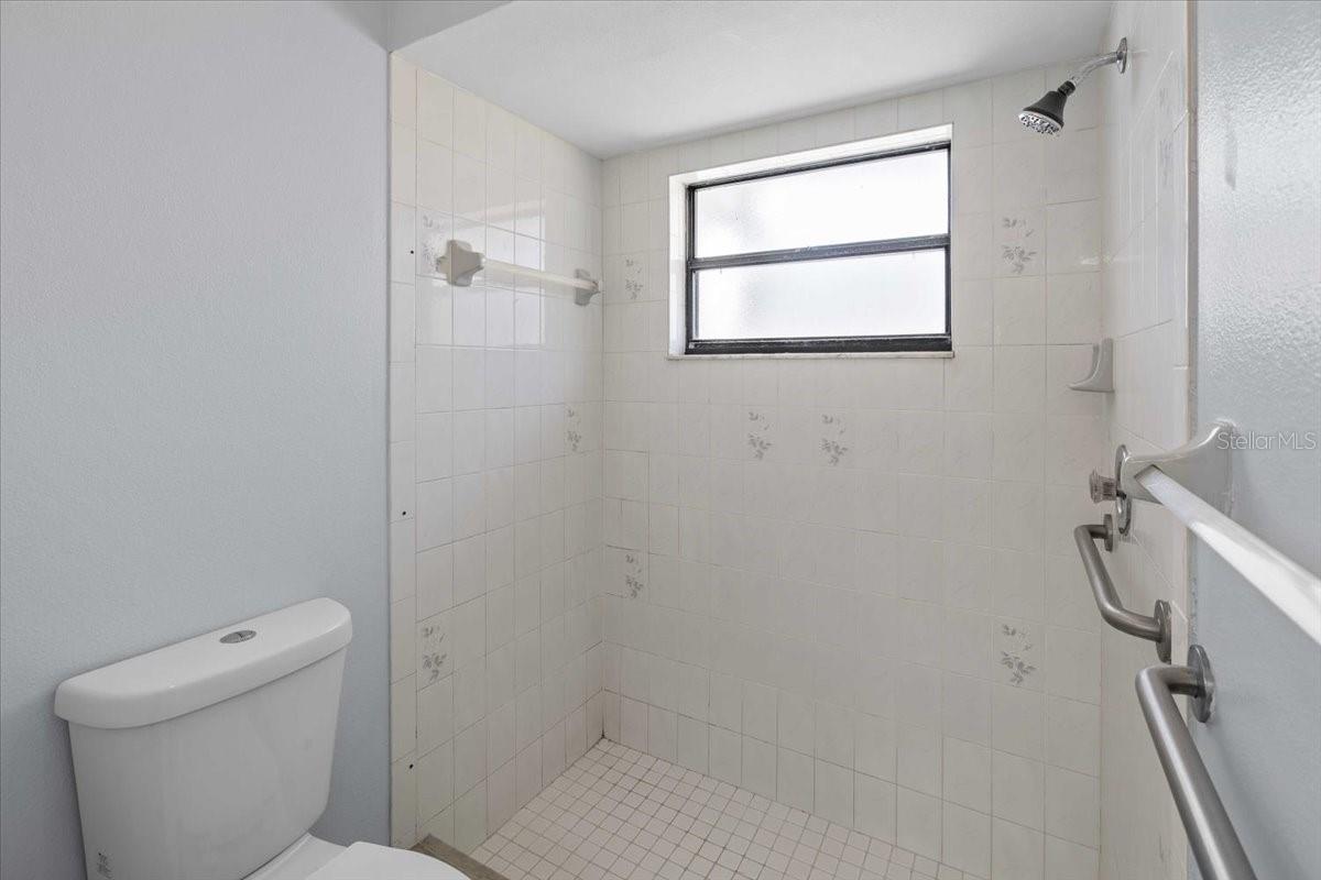 floor to ceiling tiled shower in primary