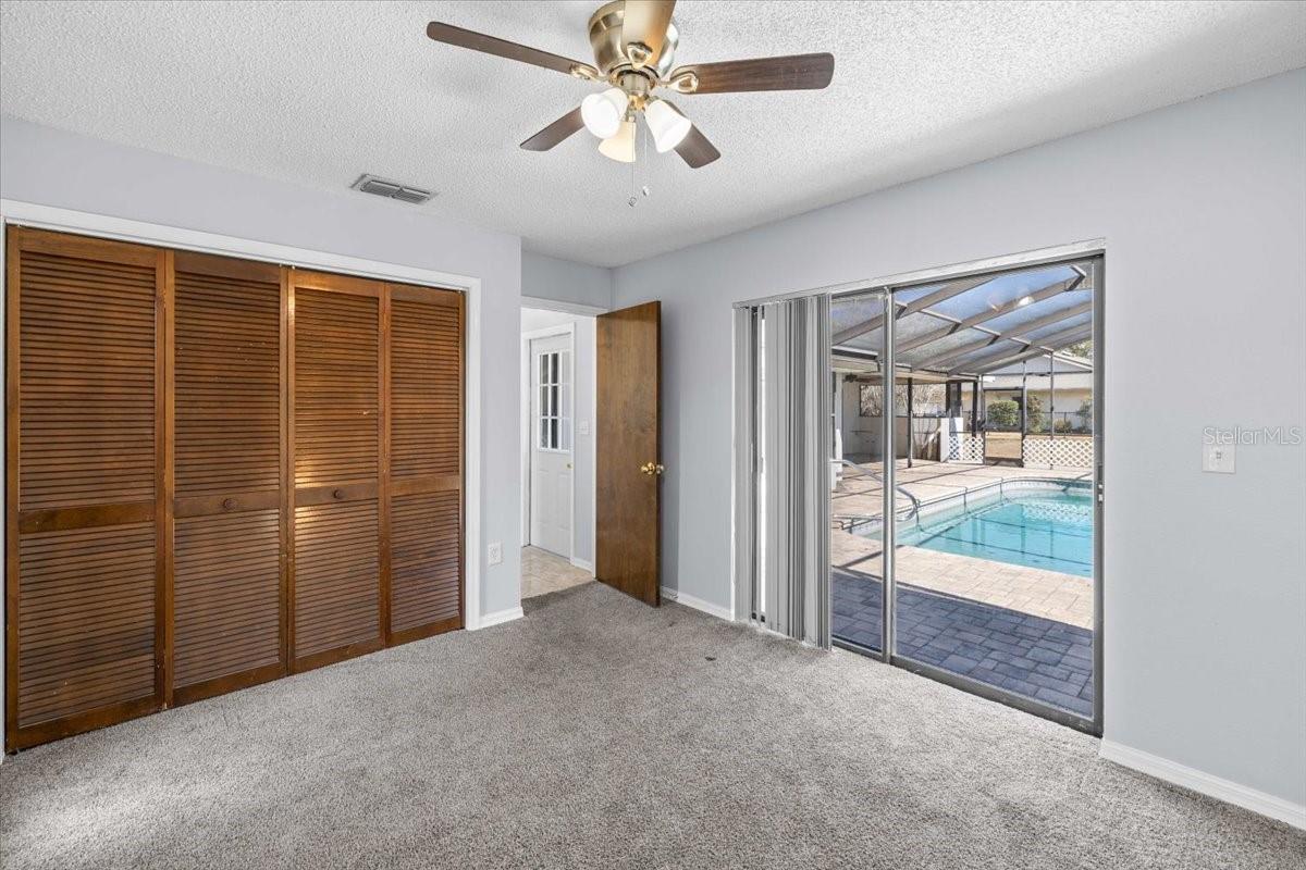 Guest bedroom 2 with sliders to pool