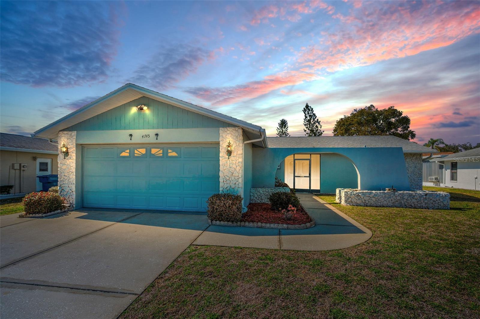 A serene sunset shot of this warm, inviting home. The warm lighting of the sunset accentuates the home's inviting features, creating a peaceful and desirable atmosphere.