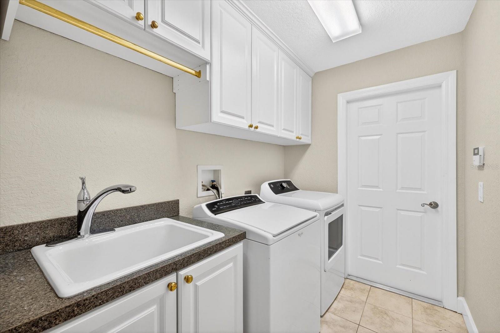 Laundry room w/ door leading to garage.
