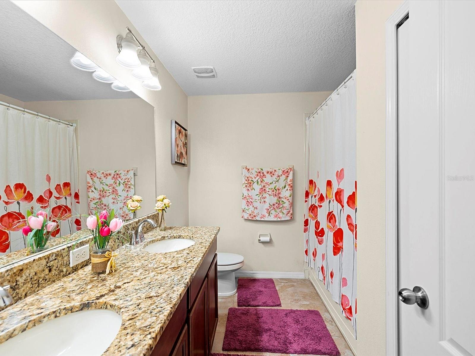 Second-floor full bathroom with dual sinks