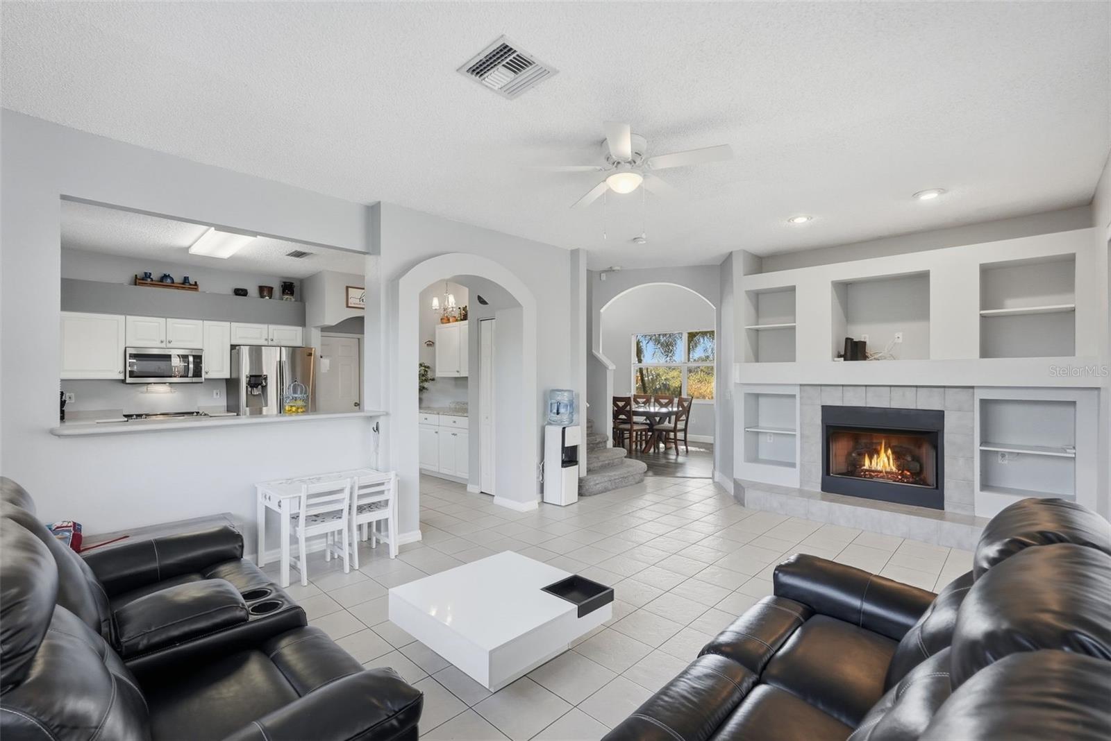 Kitchen and living room area with gas fireplace.