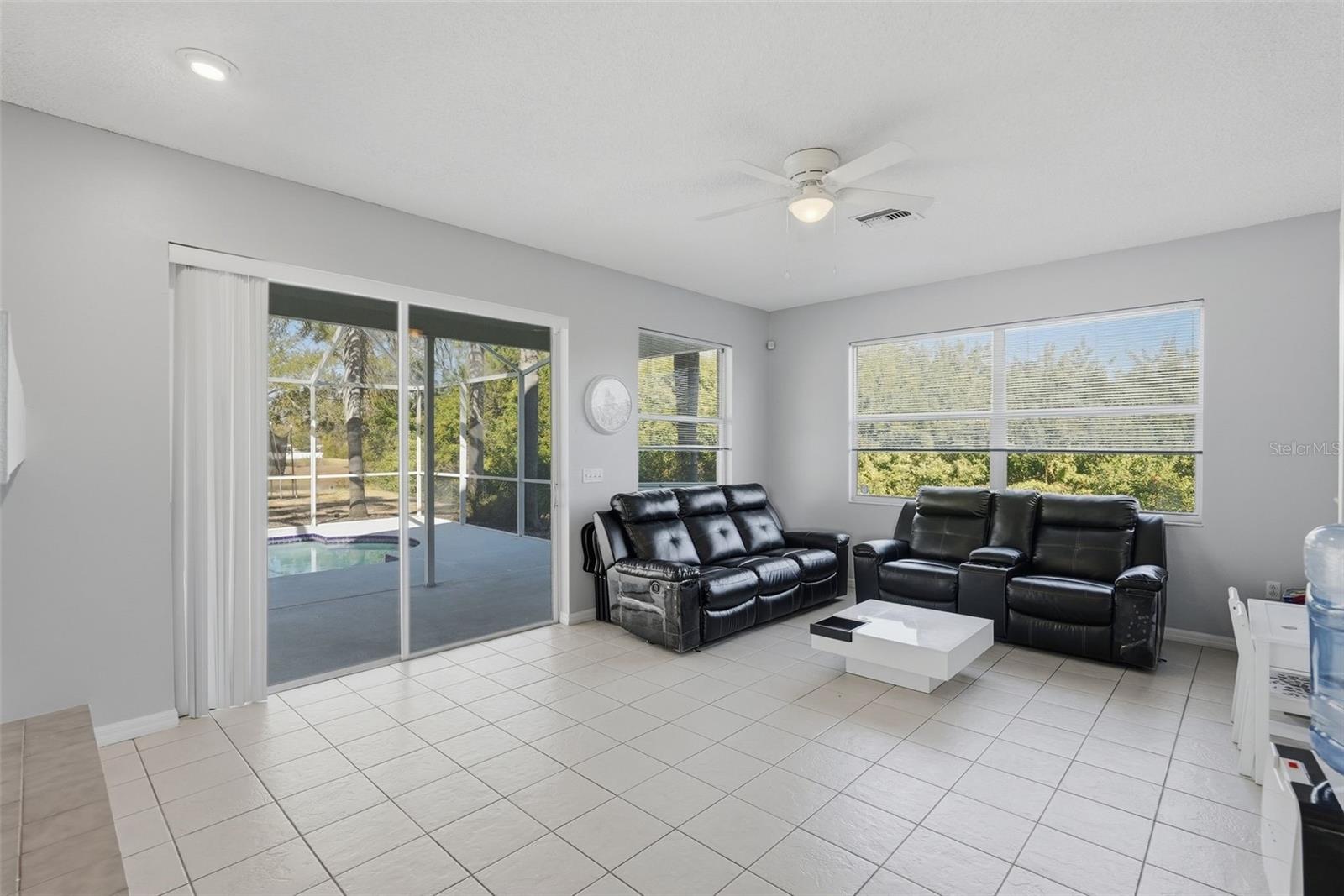Sliding door opens to the screened in pool area.  View of the living room