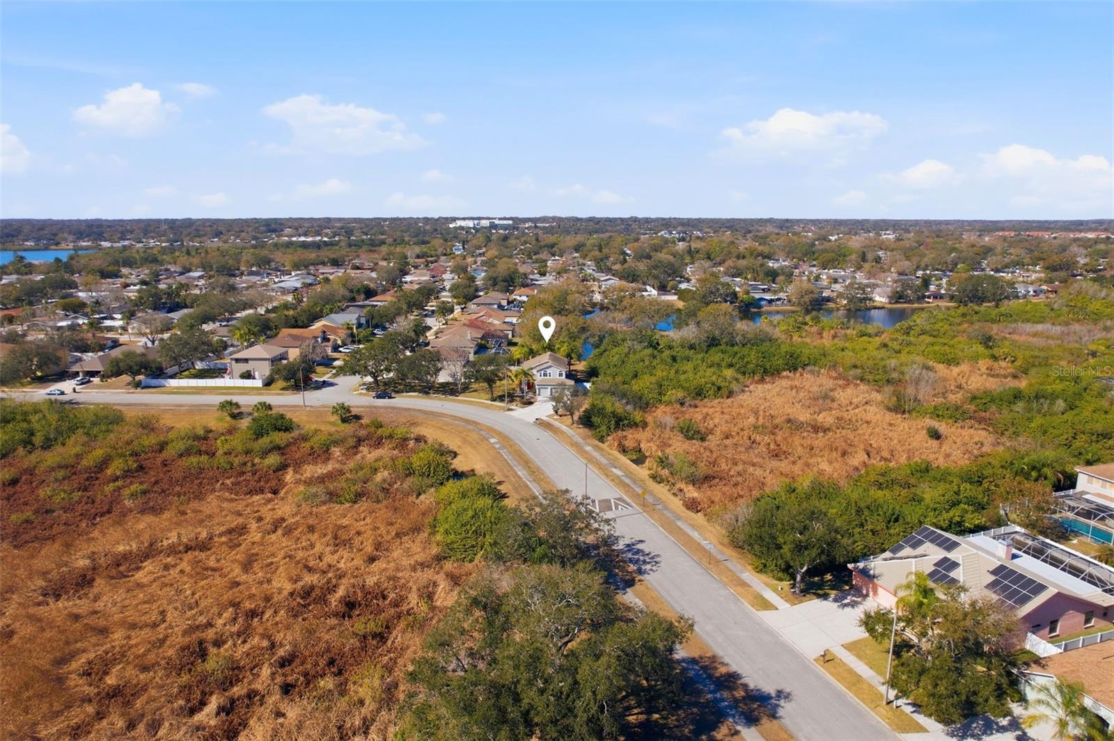 Aerial view of the street and home.  Notice how private this home is.