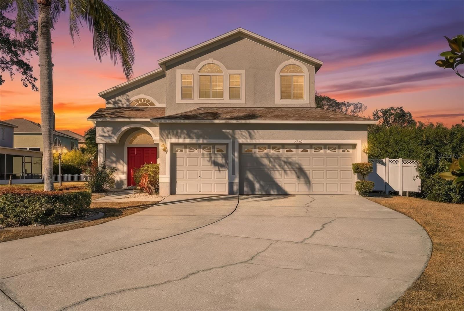A twilight view of the front of the home.  Notice that gorgeous palm.