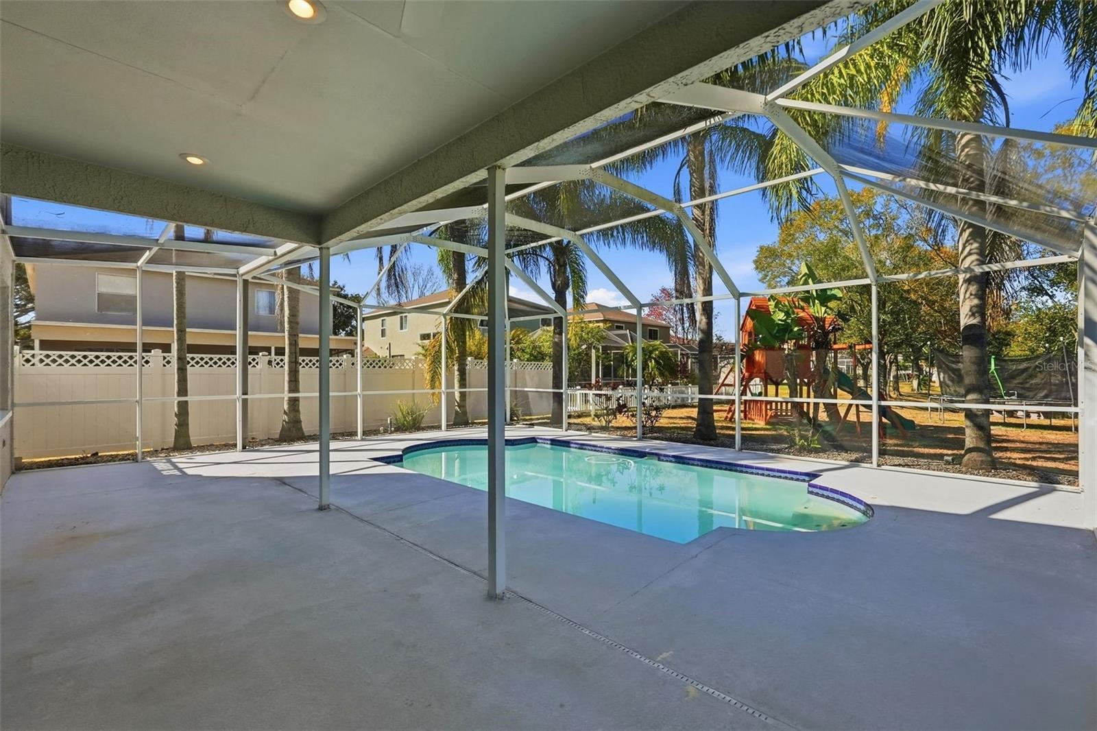 Enclosed back porch and screened in pool area.