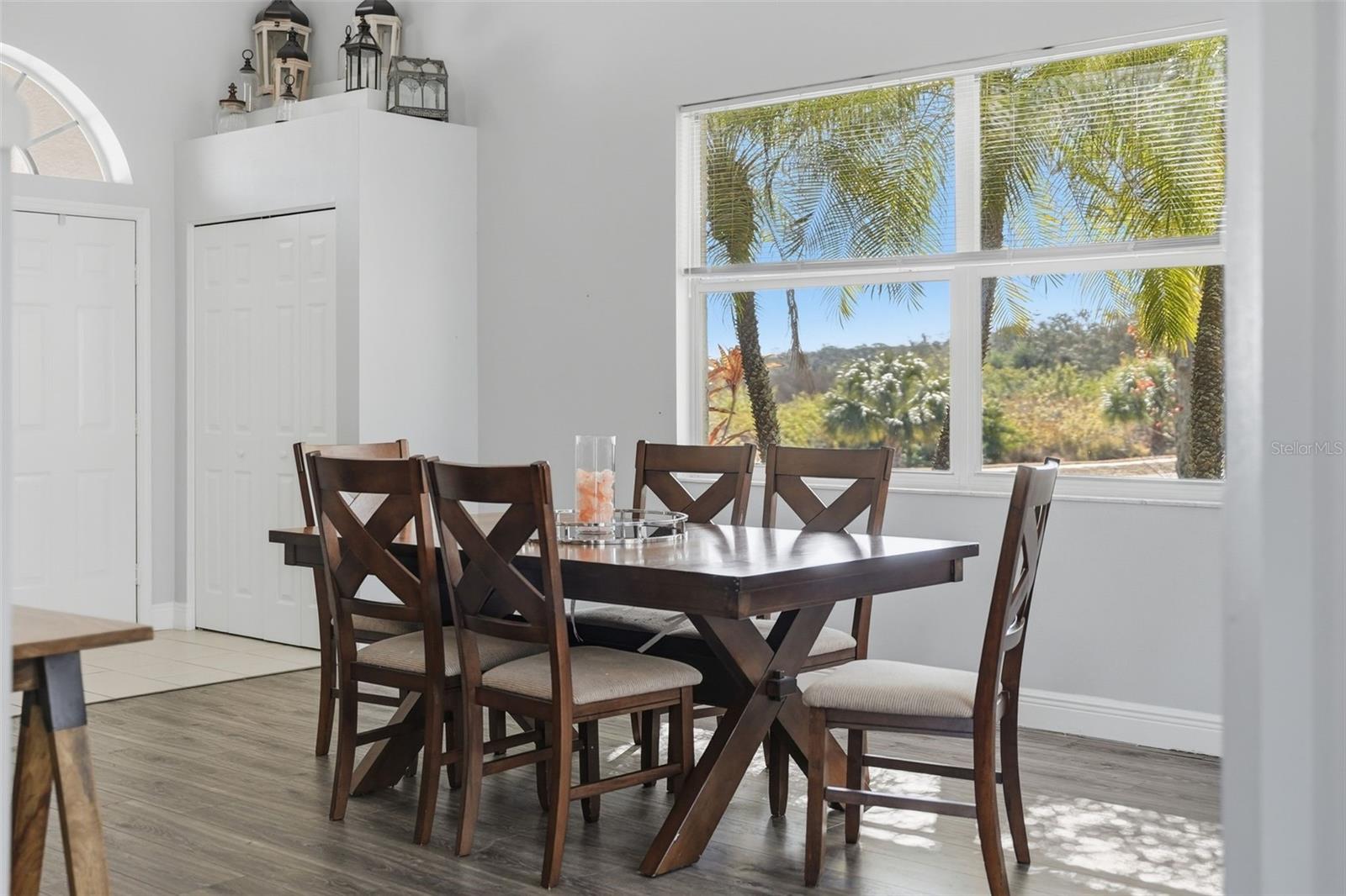 View of the front door, coat closet and dining room.