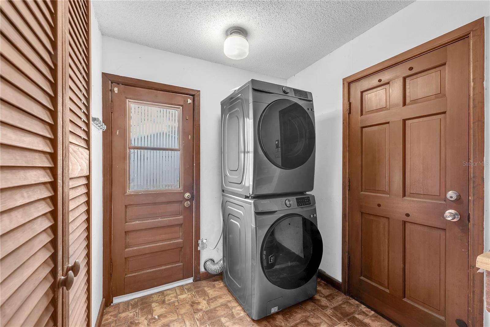 The garage includes a full-size Samsung stackable washer and dryer which convey to the buyers.  There is also access to the back patio in the garage.
