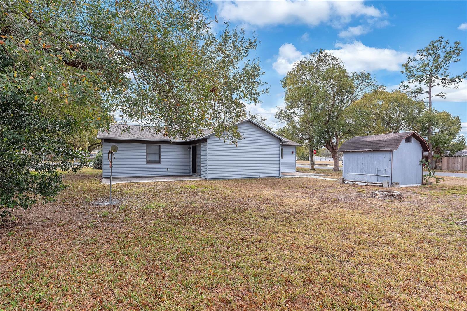 Outdoor Highlights include a large lot with plenty of space to enjoy,  private patio off the family room on the left, additional patio area outside the garage on the right and a Wooden storage shed for tools and extra storage needs.