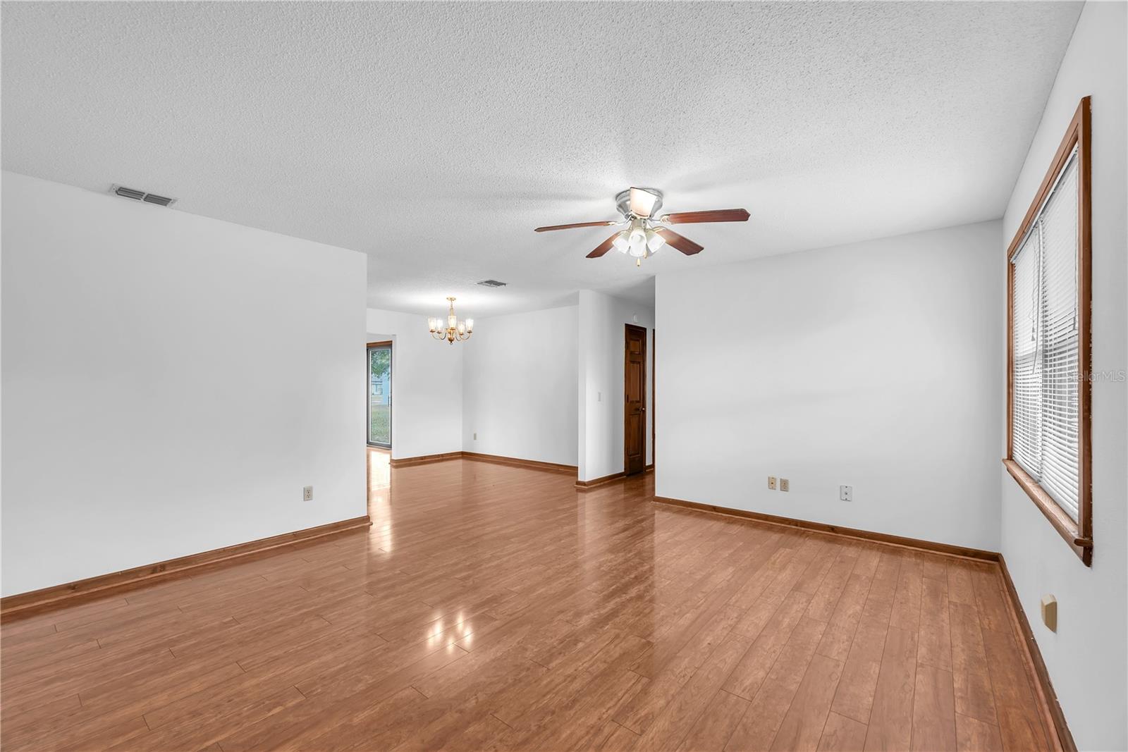 The open-concept living and dining space is filled with natural light, creating a warm and inviting atmosphere.