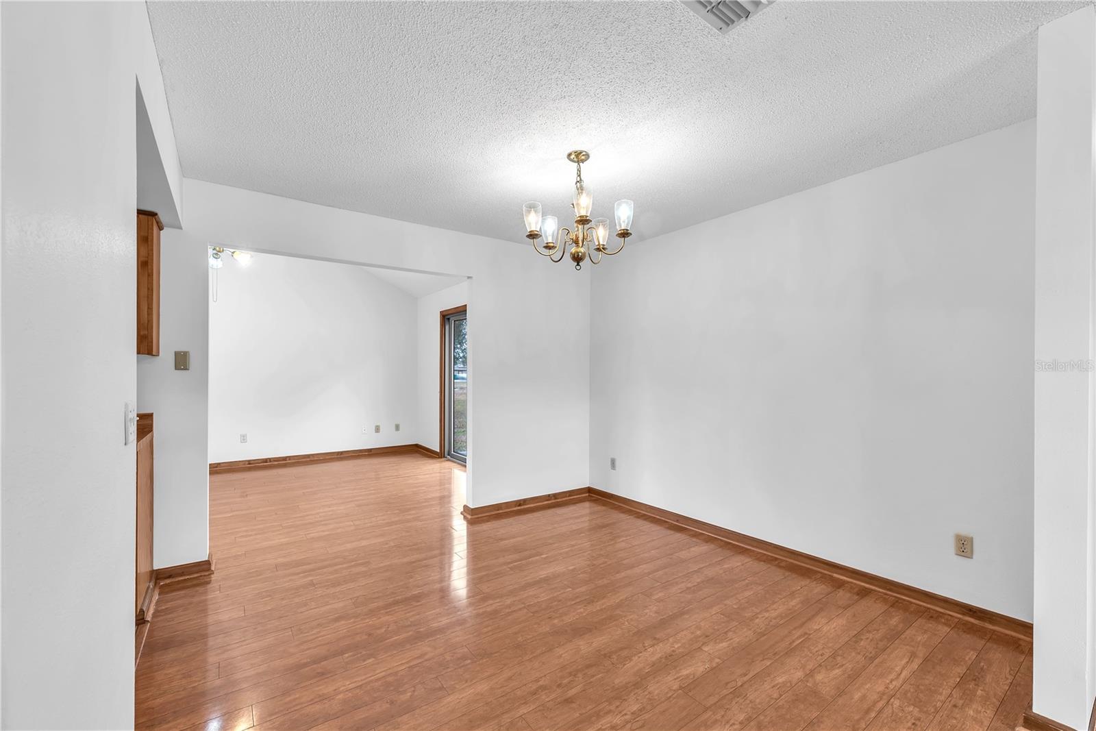 Dining room with large opening into the Family room at the rear of the home.