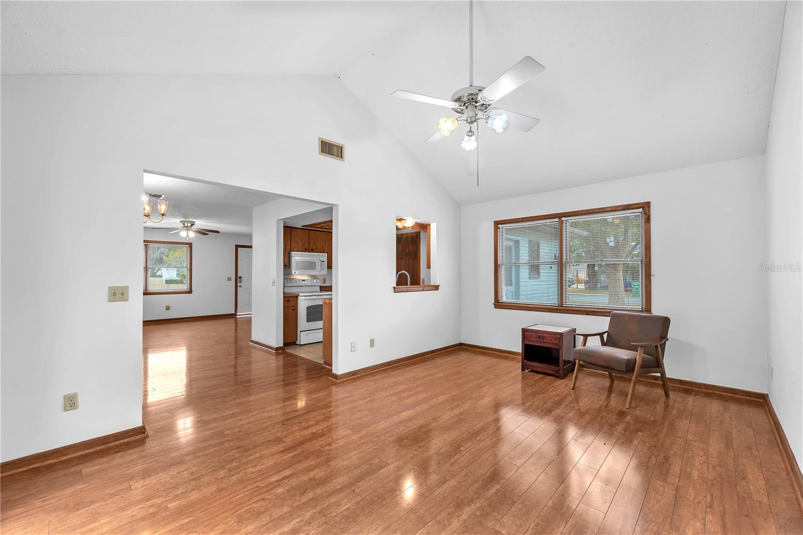 spacious family room with vaulted ceilings is the perfect spot to netflix and chill in an oversized sectional.