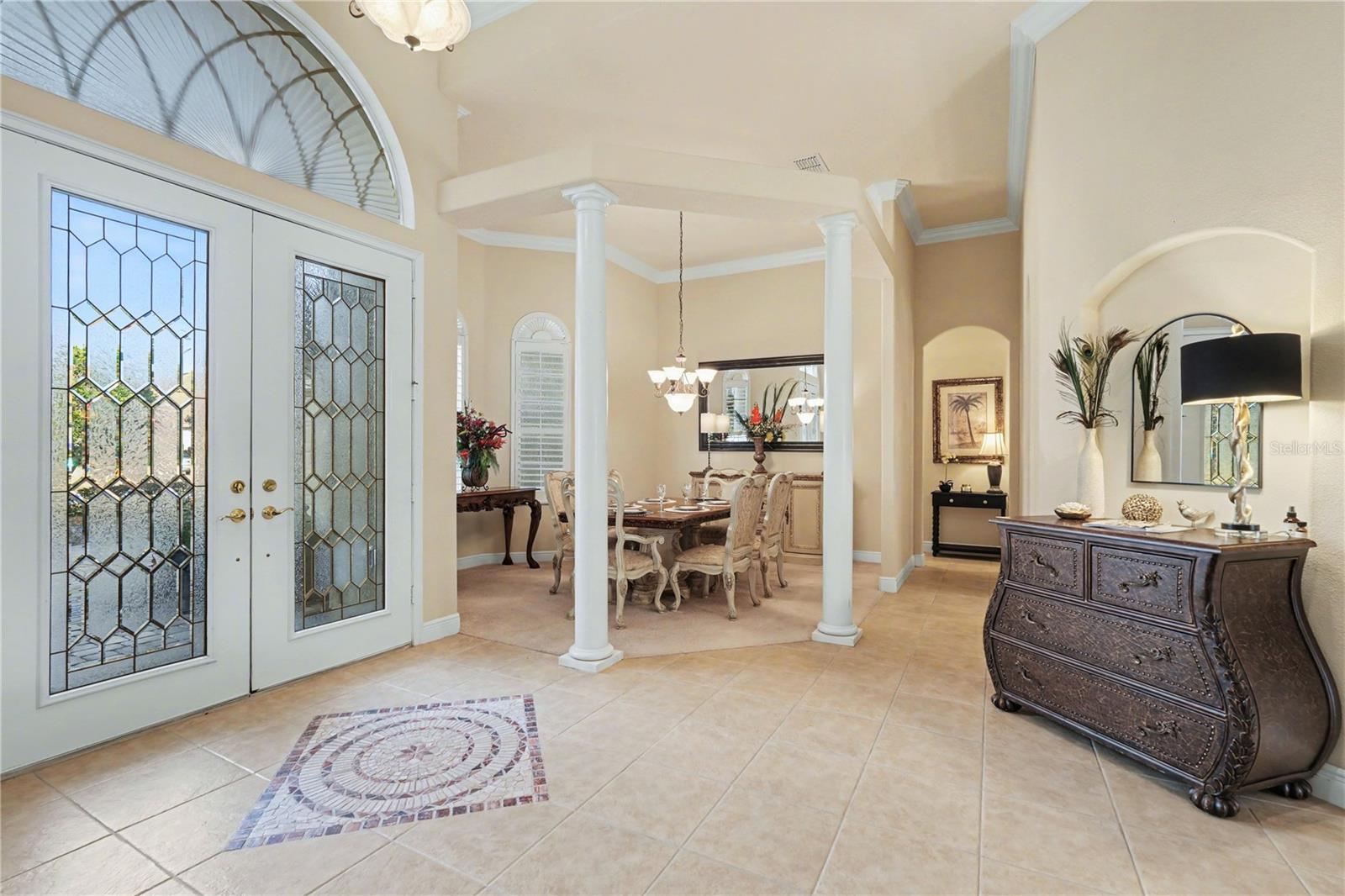 Leaded glass double doors with tile inlay accent in foyer