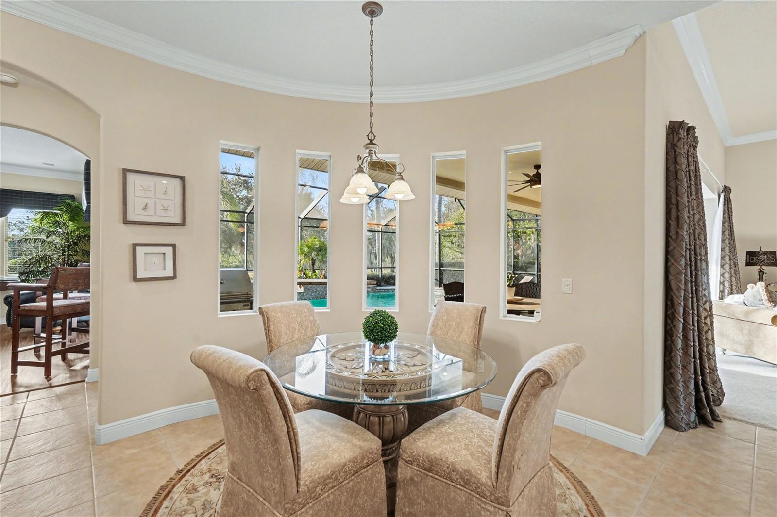 Rounded wall boasts pool & golf course views