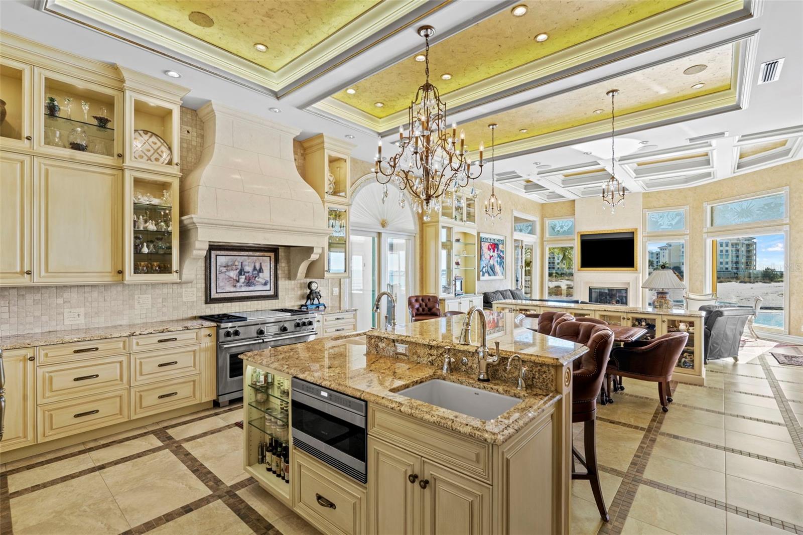The Kitchen Island has Two Sinks, a built-in Microwave and a Breakfast Bar.