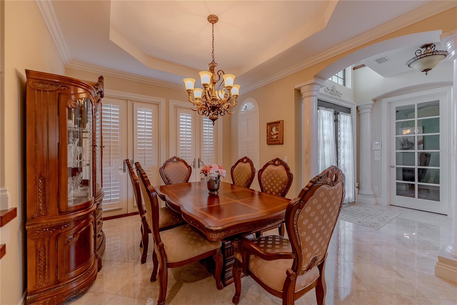 Soaring entry with imported Italian marble flooring and custom ironwork staircase.