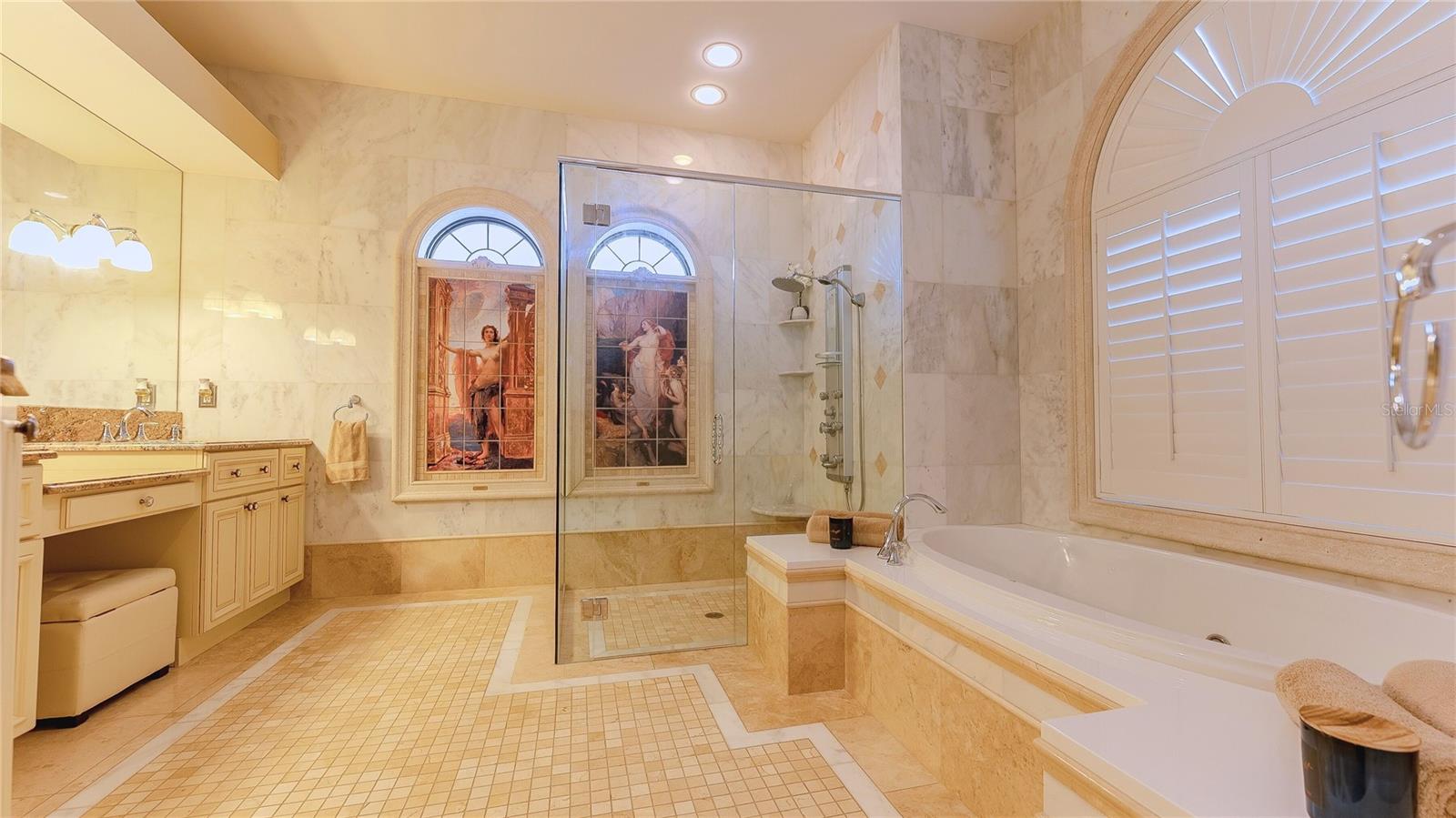 A retreat within your retreat — a light-filled bath sanctuary with dual vanities, a statement soaking tub, and a walk-through shower designed for pure unwind mode.