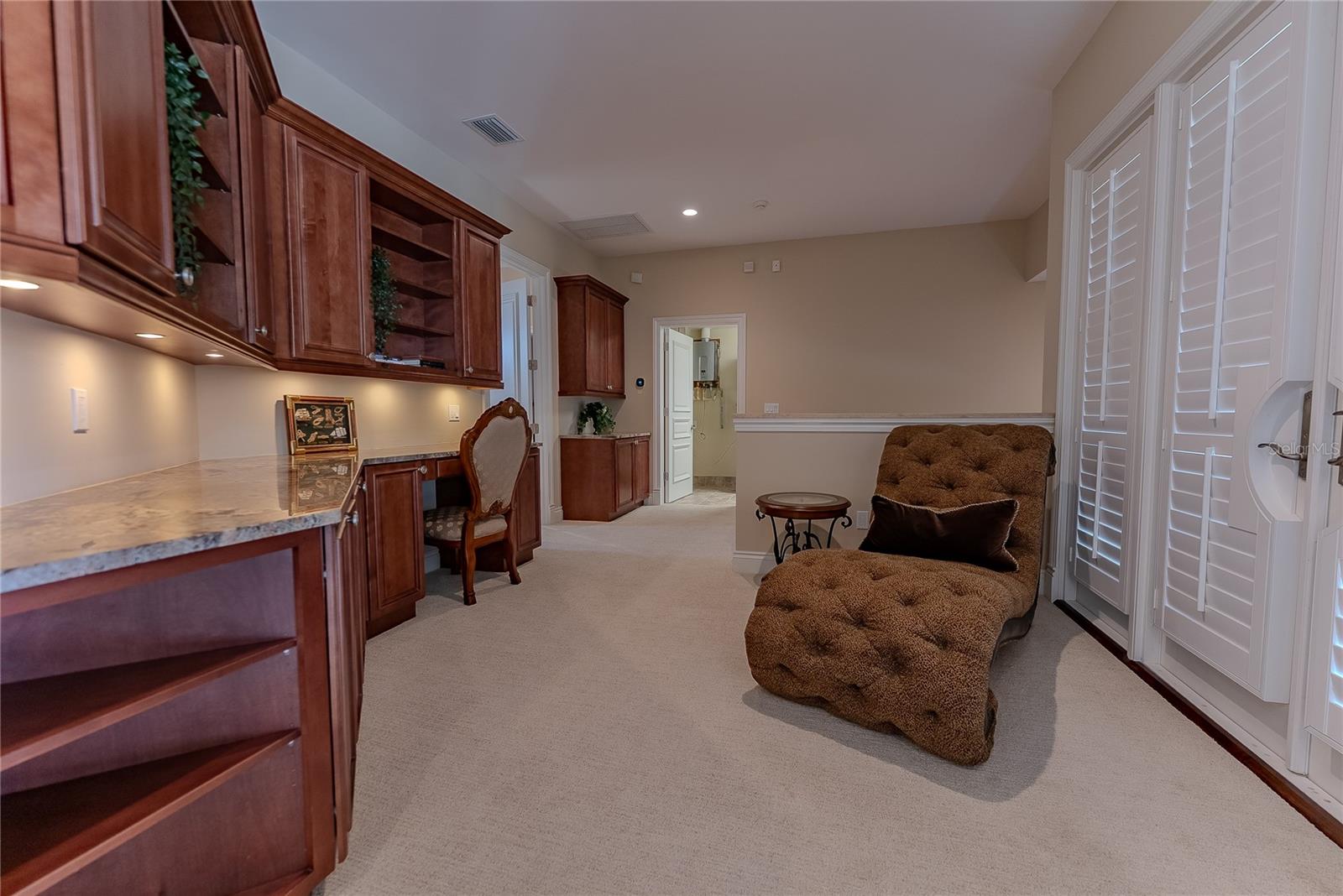 Versatile loft space with integrated built-in workstation.