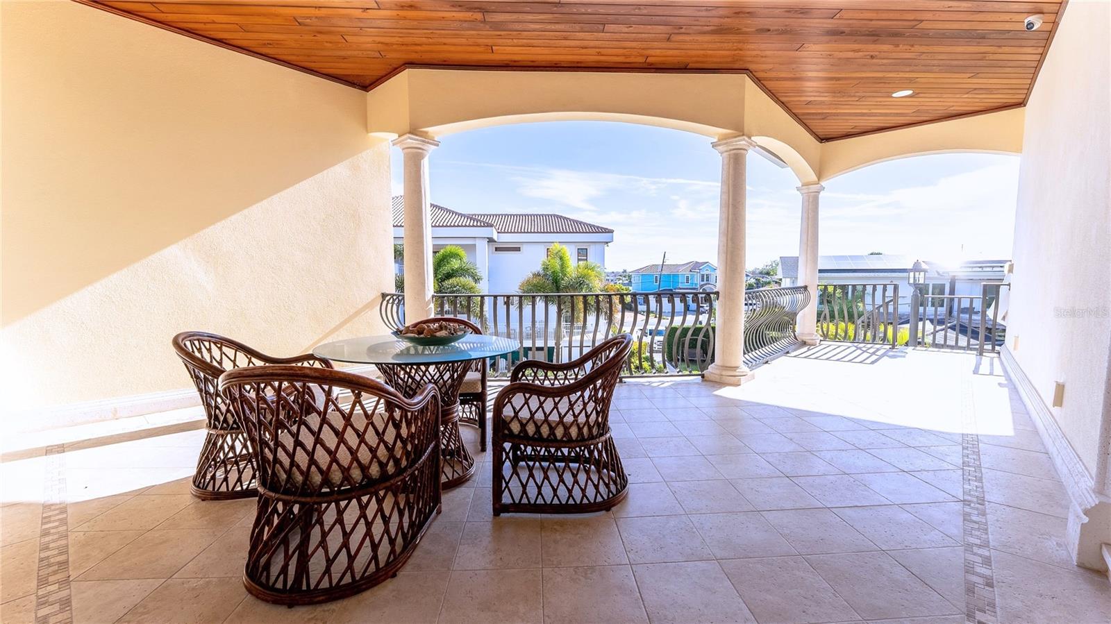 Covered outdoor living with wood-paneled ceiling and panoramic views—your private front-row seat to sunrise coffee and sunset cocktails.