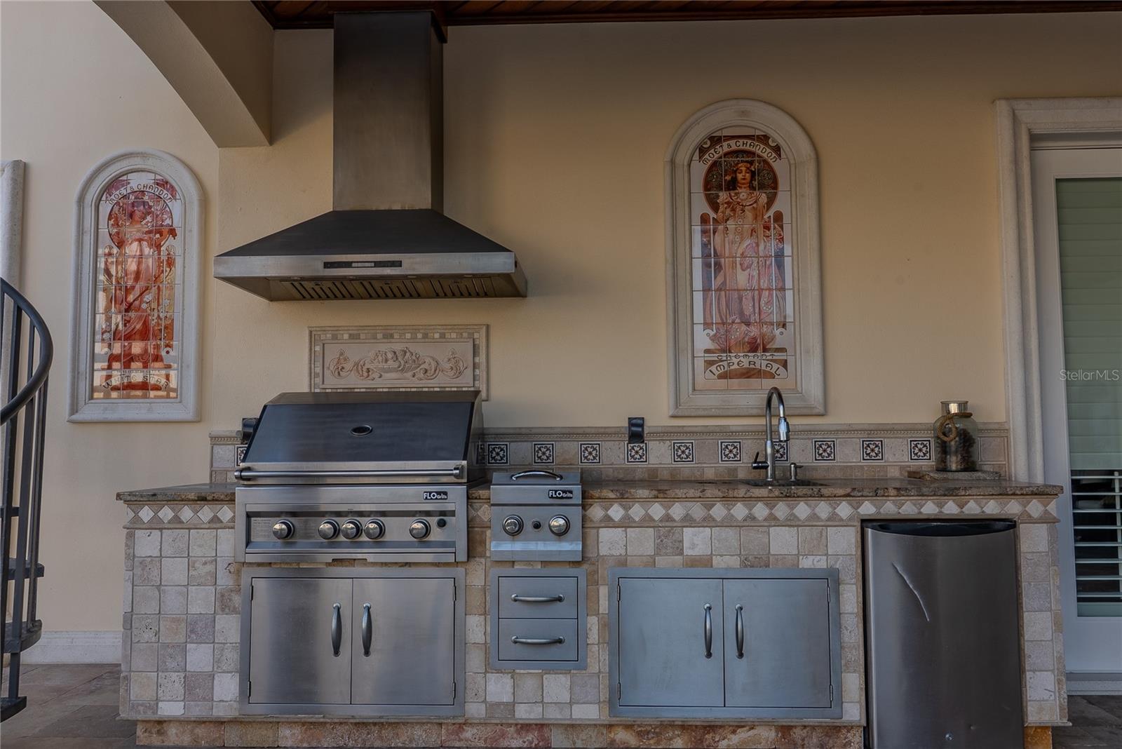 Covered outdoor kitchen featuring a built-in infrared gas grill.