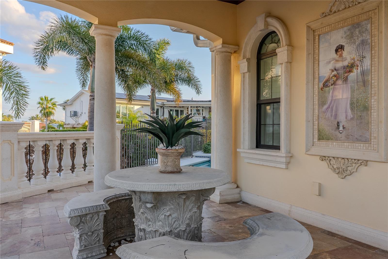 Covered portico with dining table, ideal for al fresco gatherings.