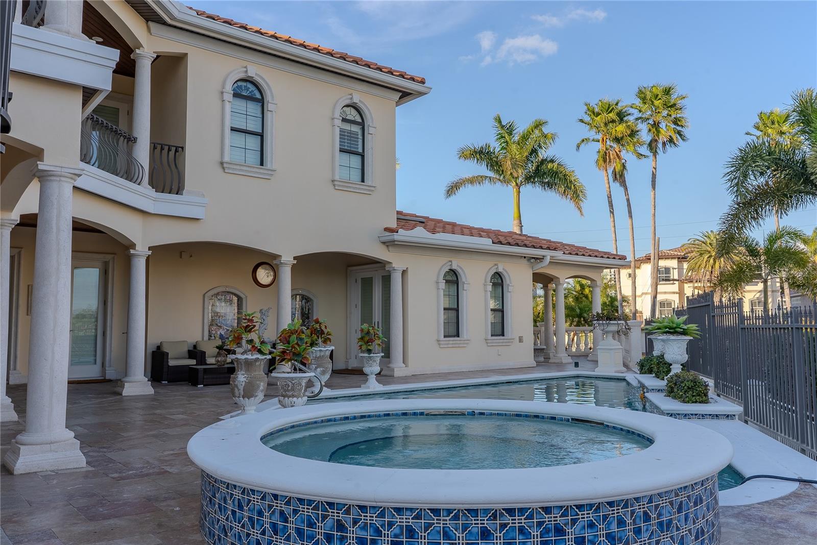 Resort-style pool surrounded by lush landscaping and private courtyard setting.