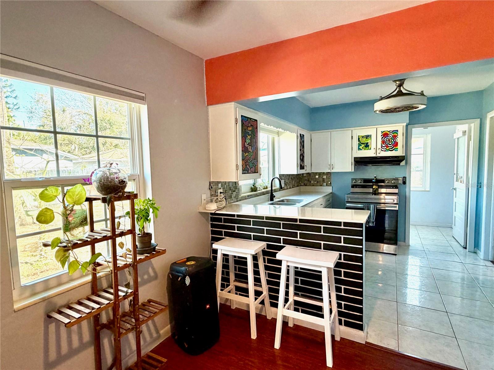 Abundant light and adorable breakfast bar.