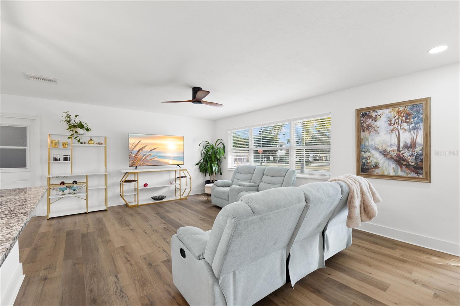 Architectural details include upgraded 5-inch baseboards creating a clean, finished look throughout the space. Recessed lighting and a modern ceiling fan add comfort and functionality.