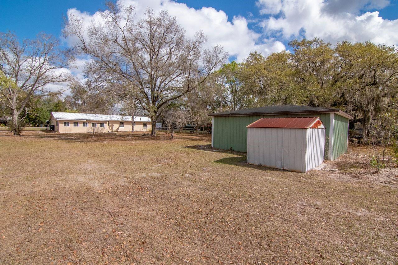 Back of the home - Florida Room add on with Workshop and Shed