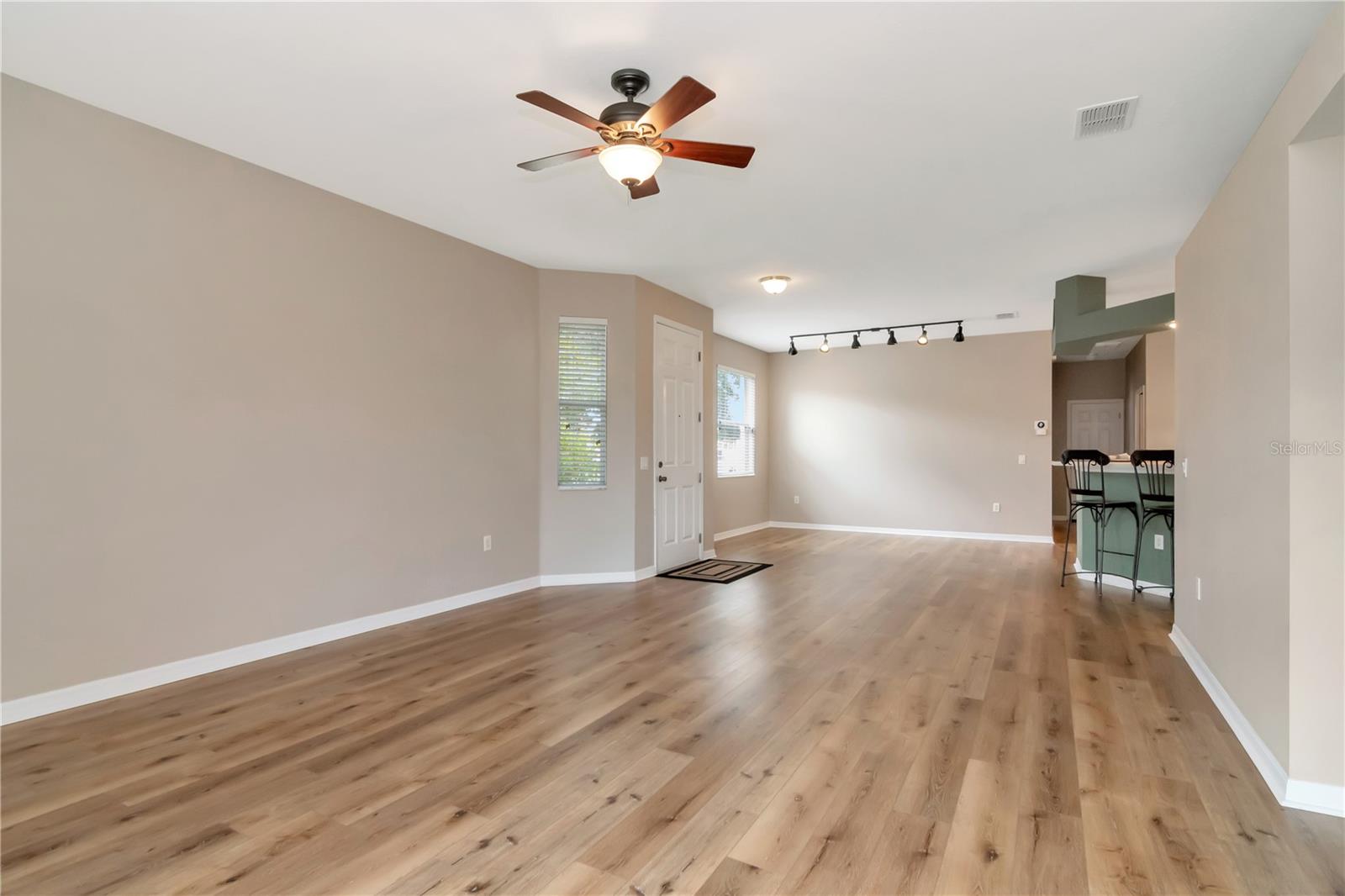 Seamless living and dining areas featuring laminate flooring.