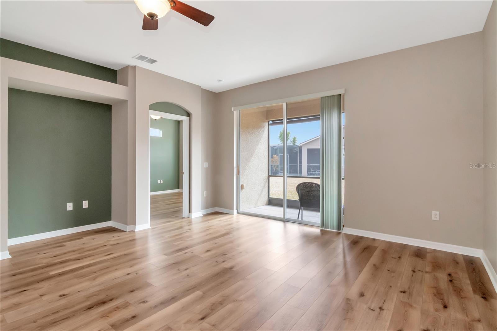 Living room with entry leading to the primary bedroom.