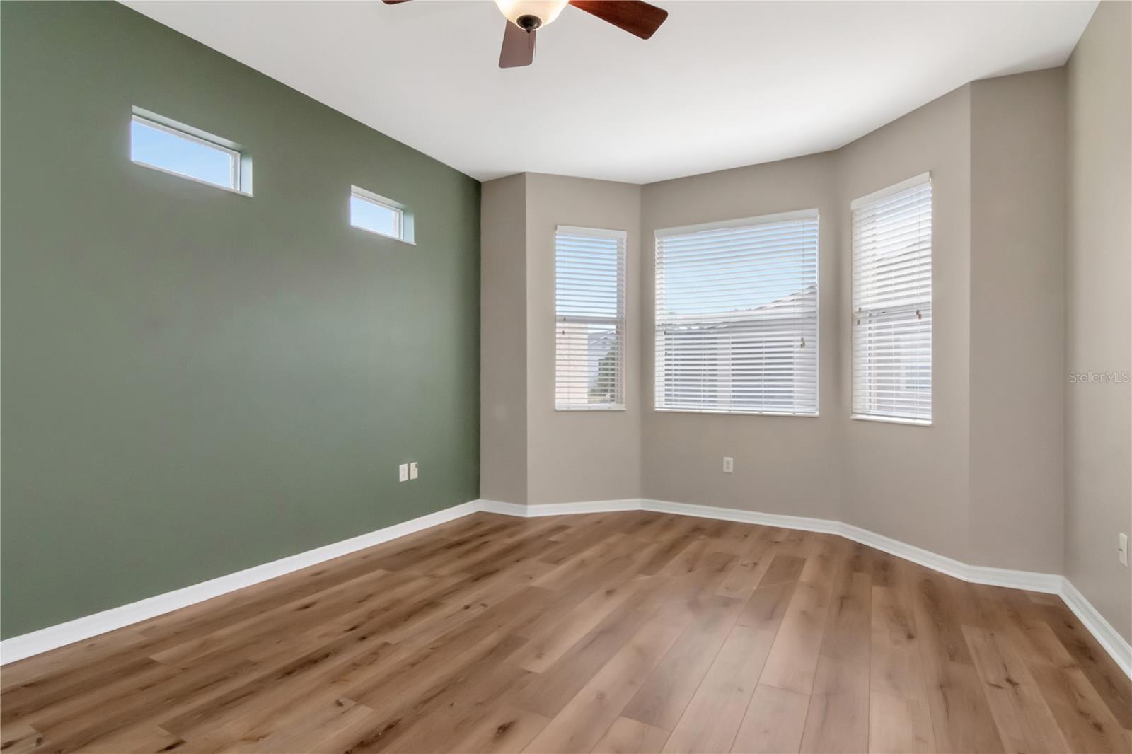 Primary bedroom featuring bay window and natural light.
