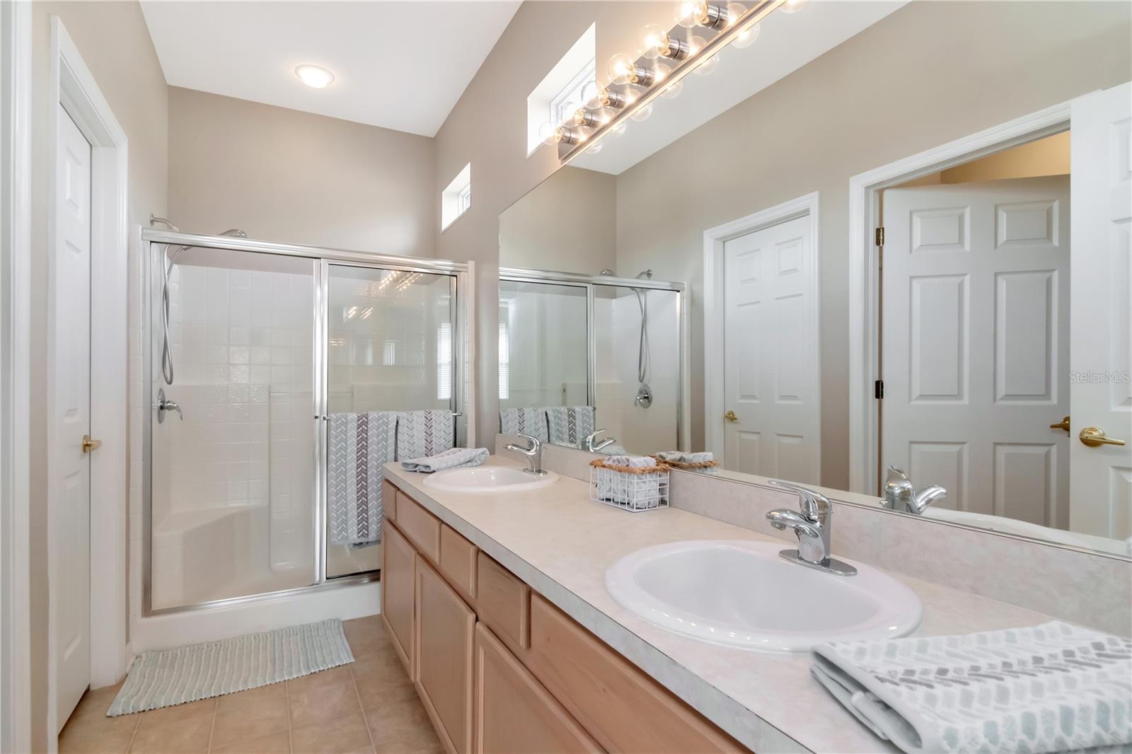 Primary en-suite with double vanity and walk-in shower.