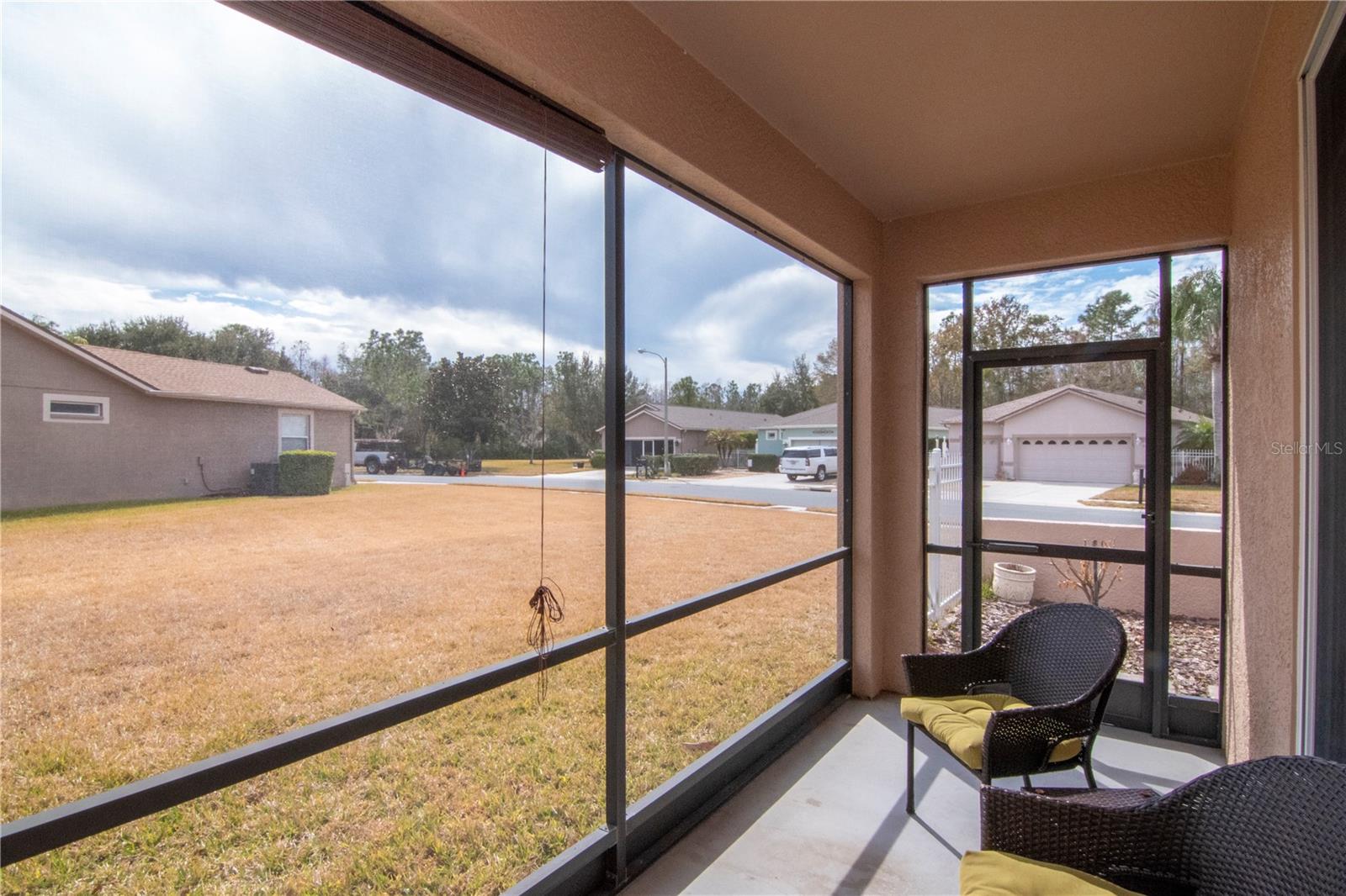 Covered lanai with generous yard offering potential for future expansion.