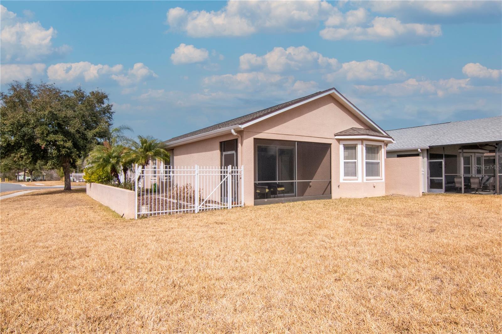 Rear exterior with spacious backyard.