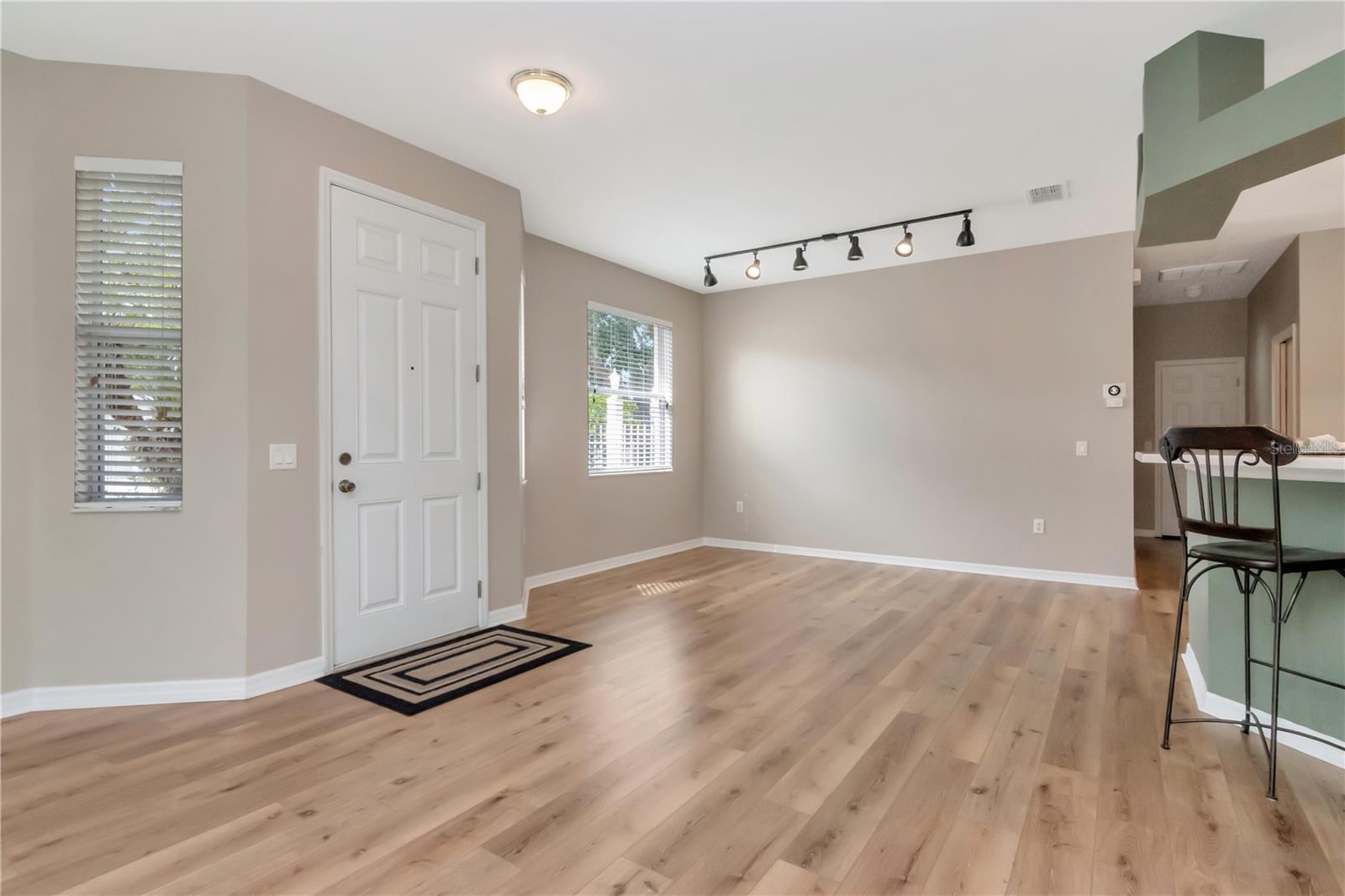 Welcoming entry leading to open living and dining space.