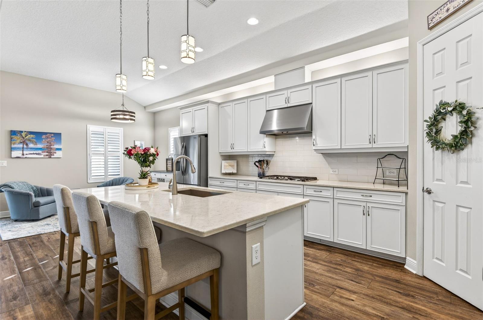 Quartz countertops, stainless steel appliances, island, hooded range to exterior, walk in pantry.