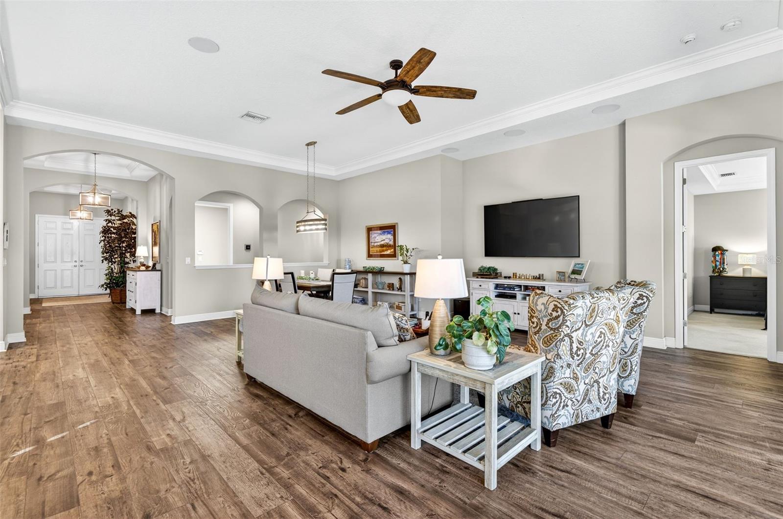 Living/dining area. Primary bedroom to the right.