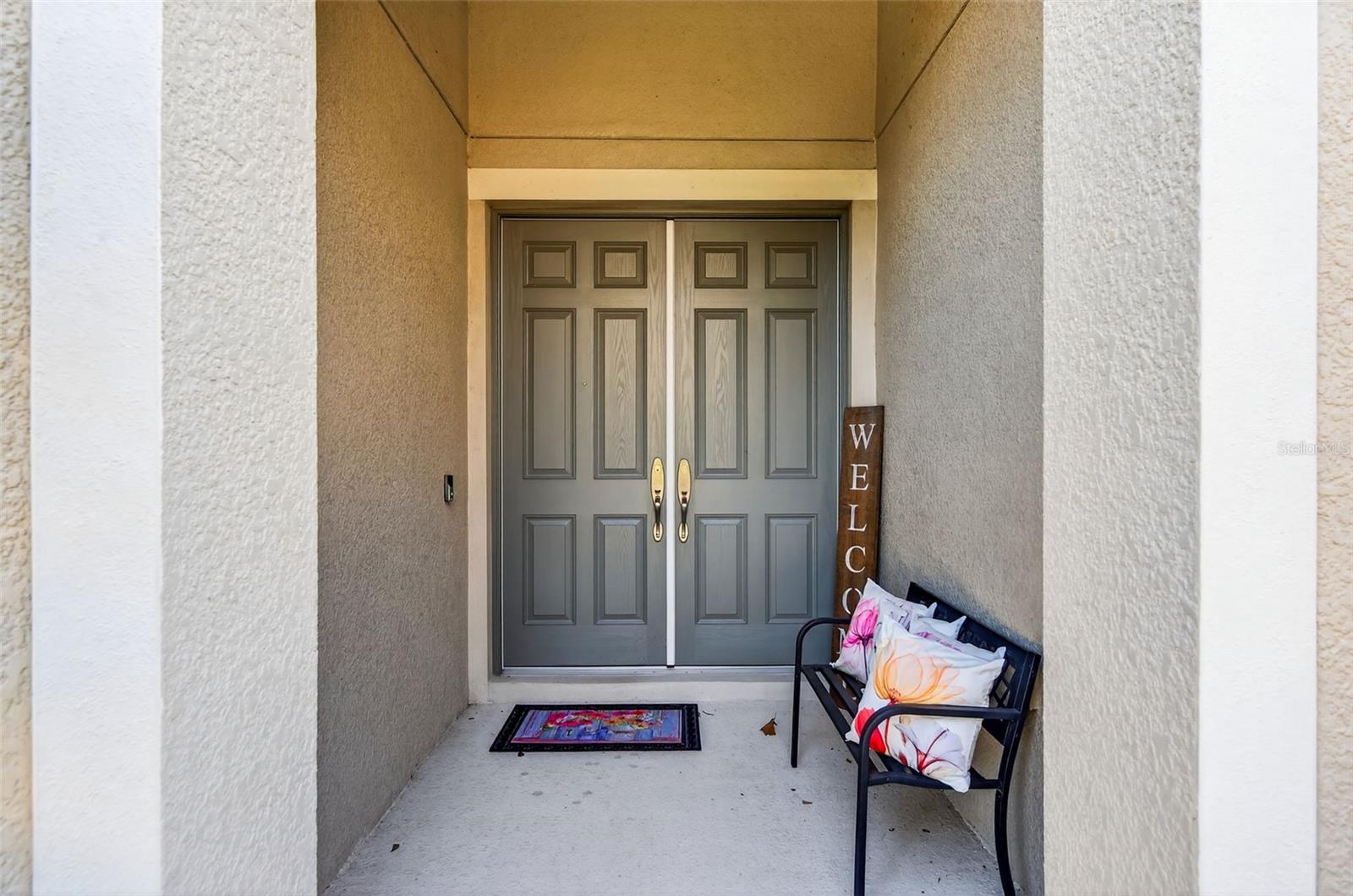 Double door, high ceiling covered entry