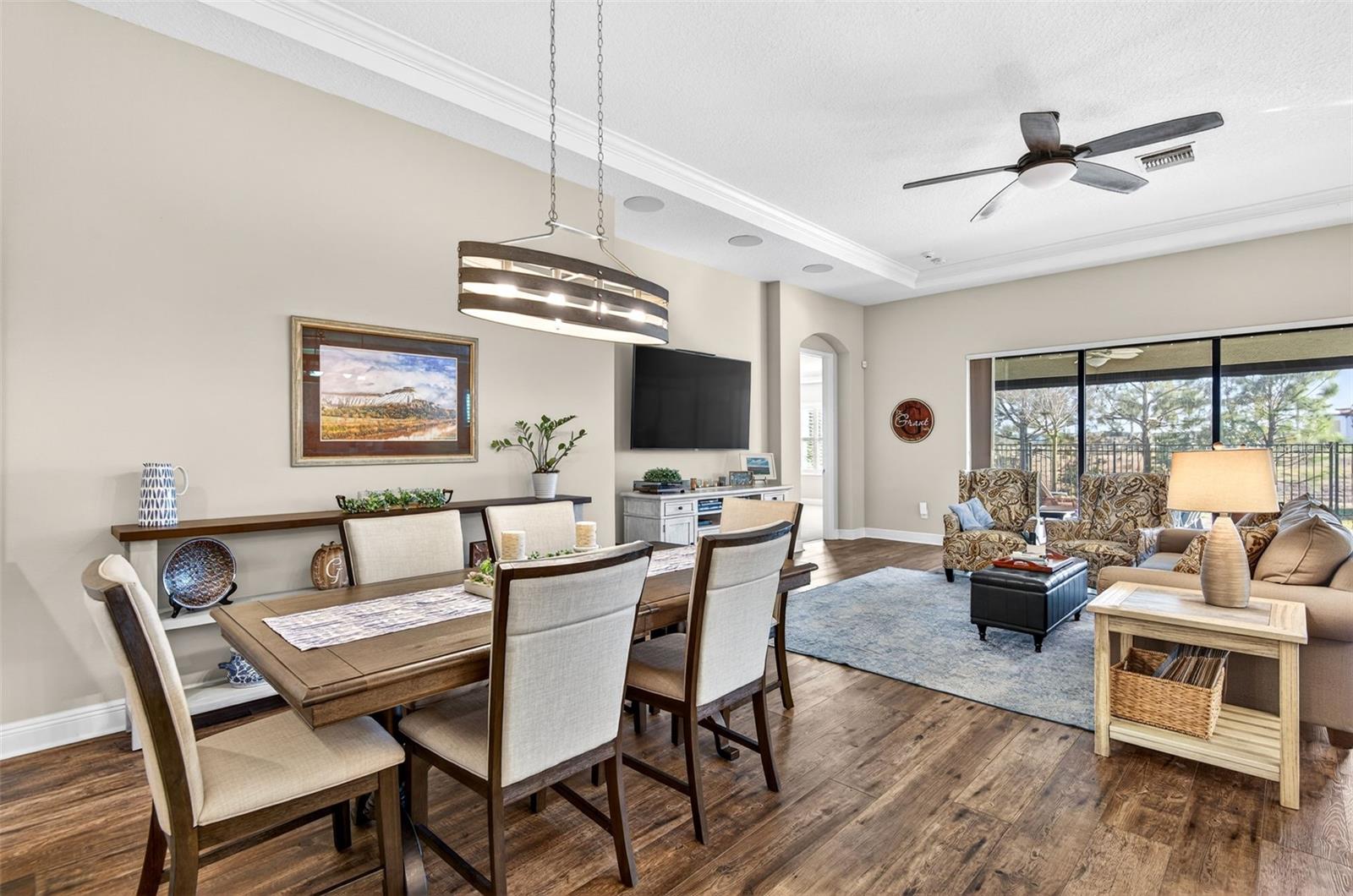 Dining room/living area combination with triple sliding glass doors that open completely to the covered lanai