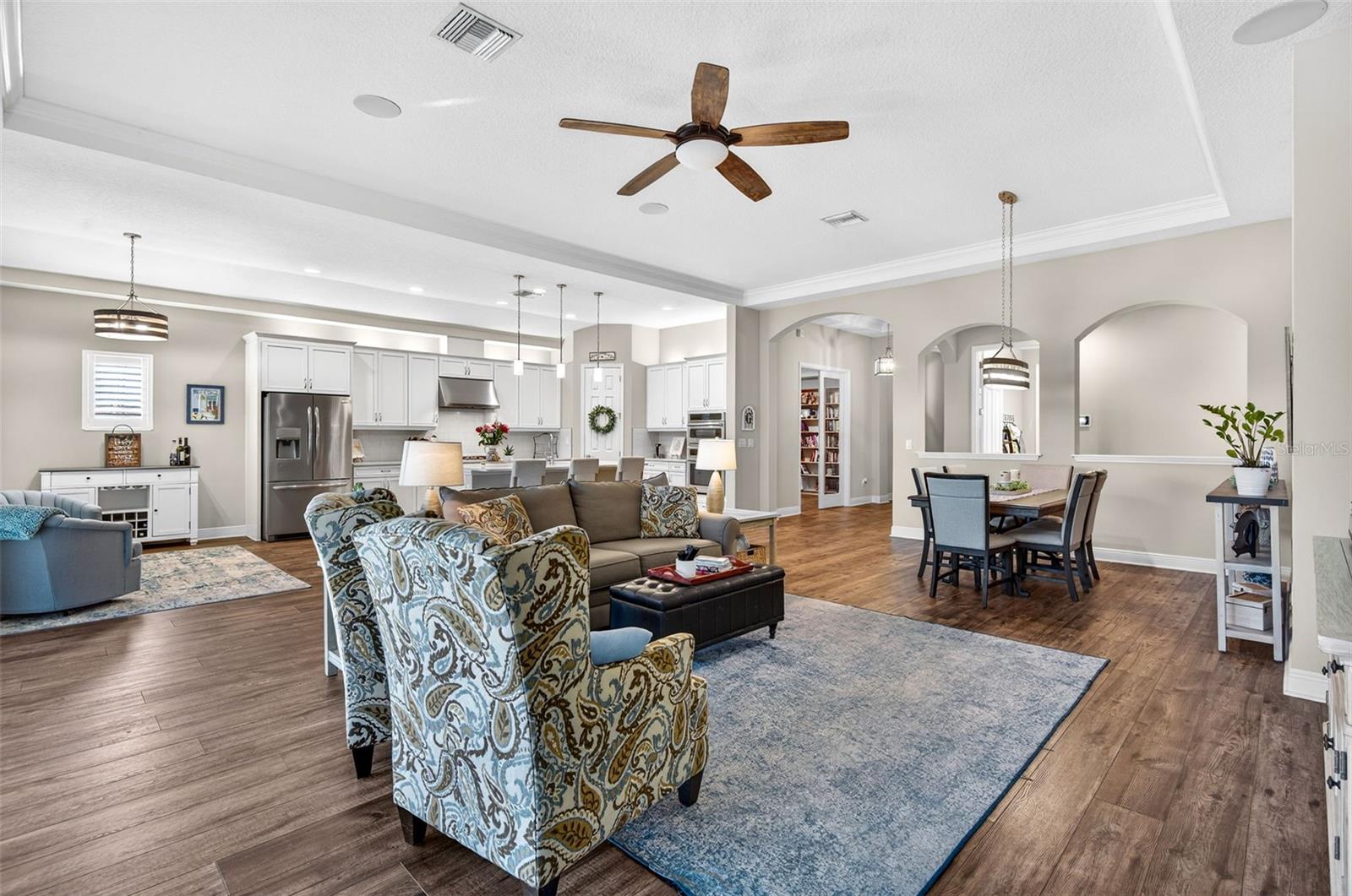 Open living floor plan with tall ceiling and architectural features